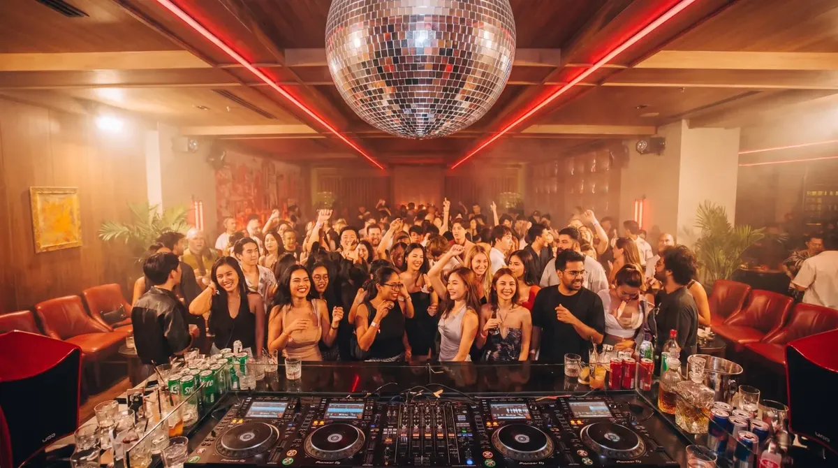 A full floor dancing under the mirror ball at Baccarat Bangkok